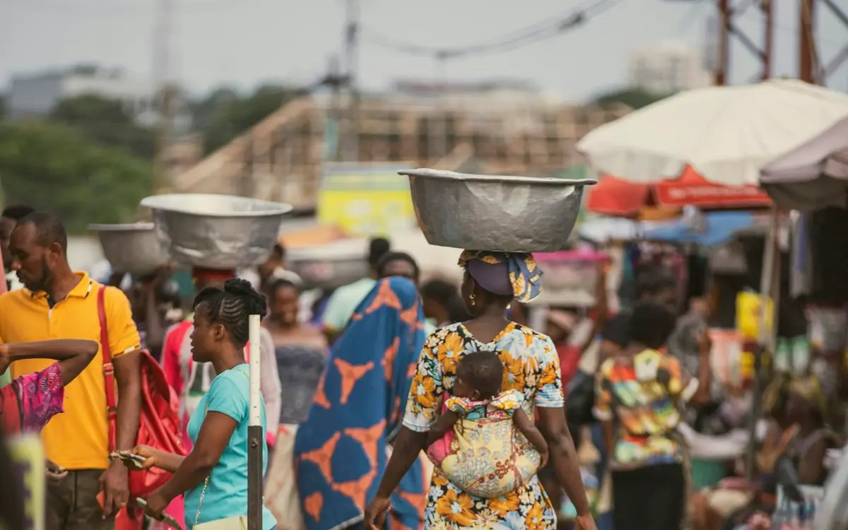 Shoppers walking through a busy street market
